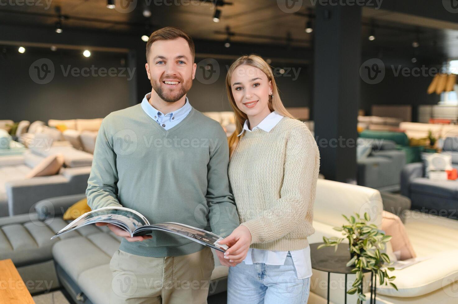 Married couple chooses the best new sofa in a furniture store photo