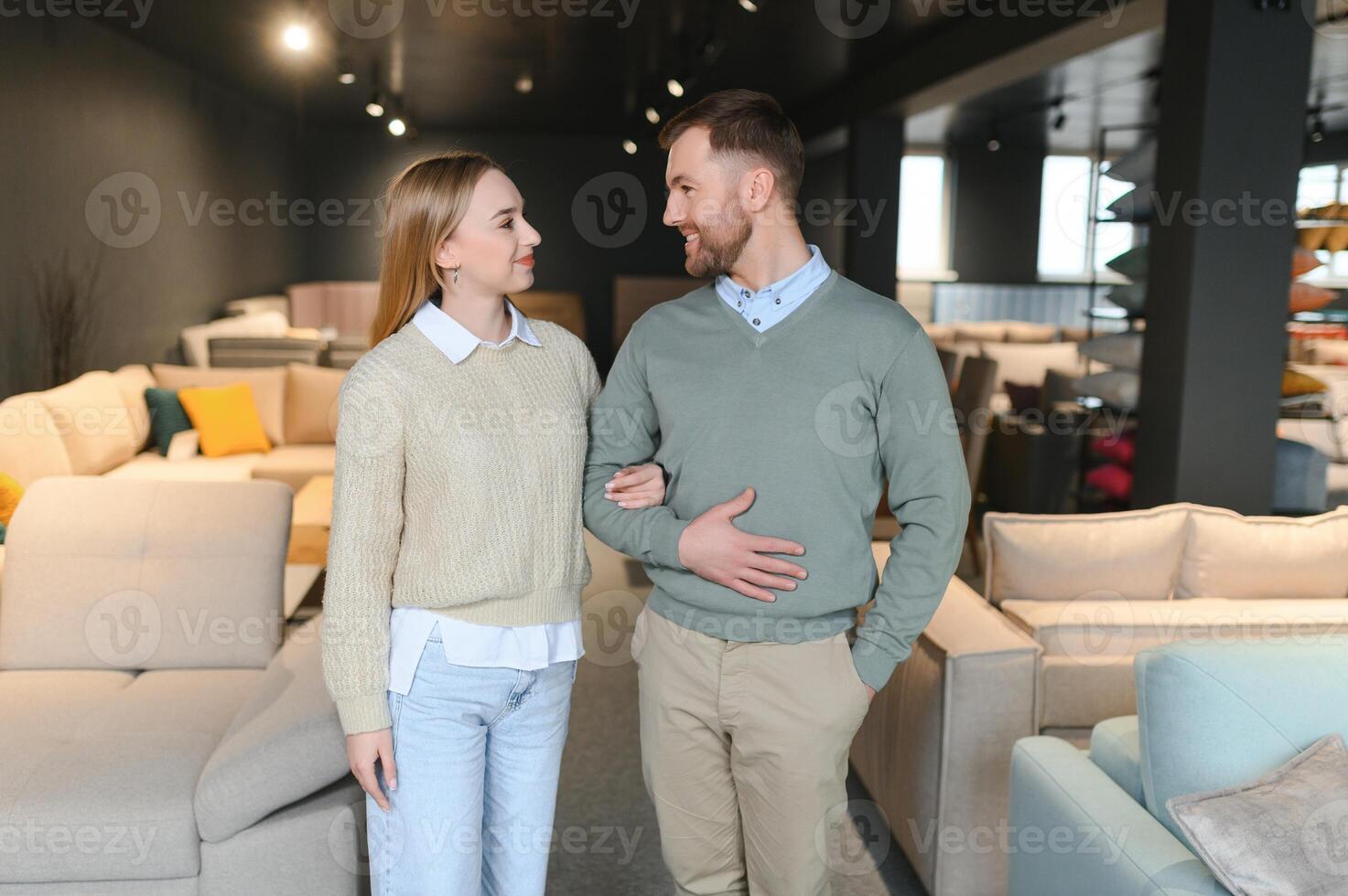 Happy couple choosing furniture in store photo