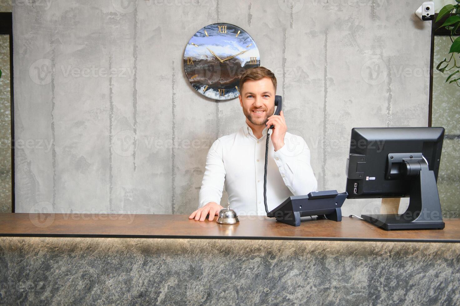 Portrait of receptionist at desk in lobby photo