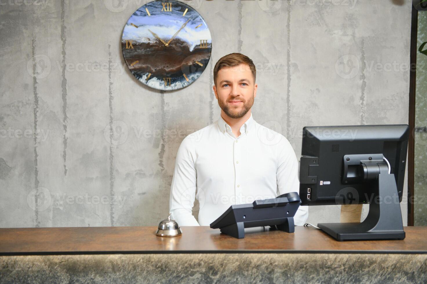 Receptionist at desk in lobby photo