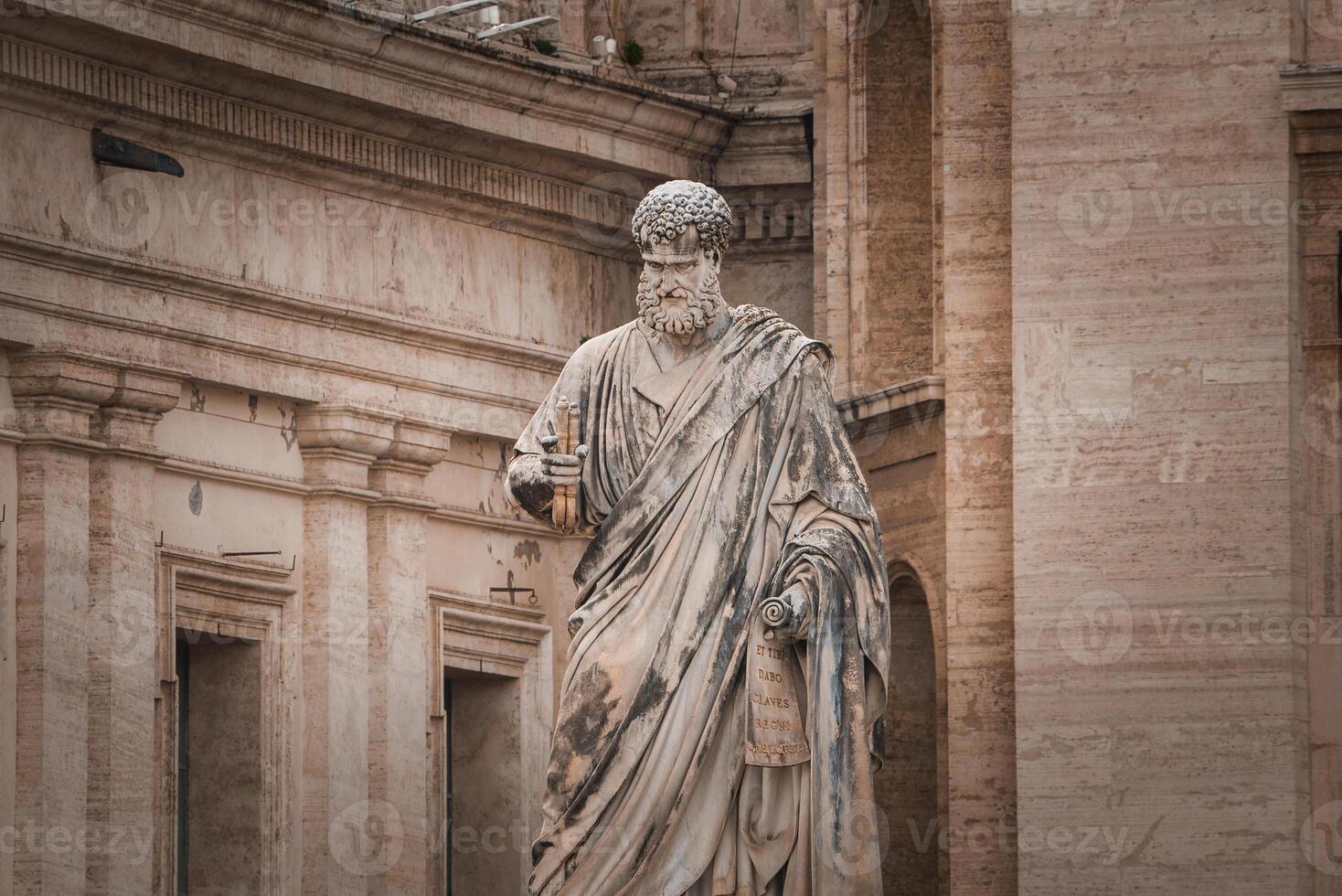 Ancient stone statue of bearded figure with scroll in Vatican City. photo