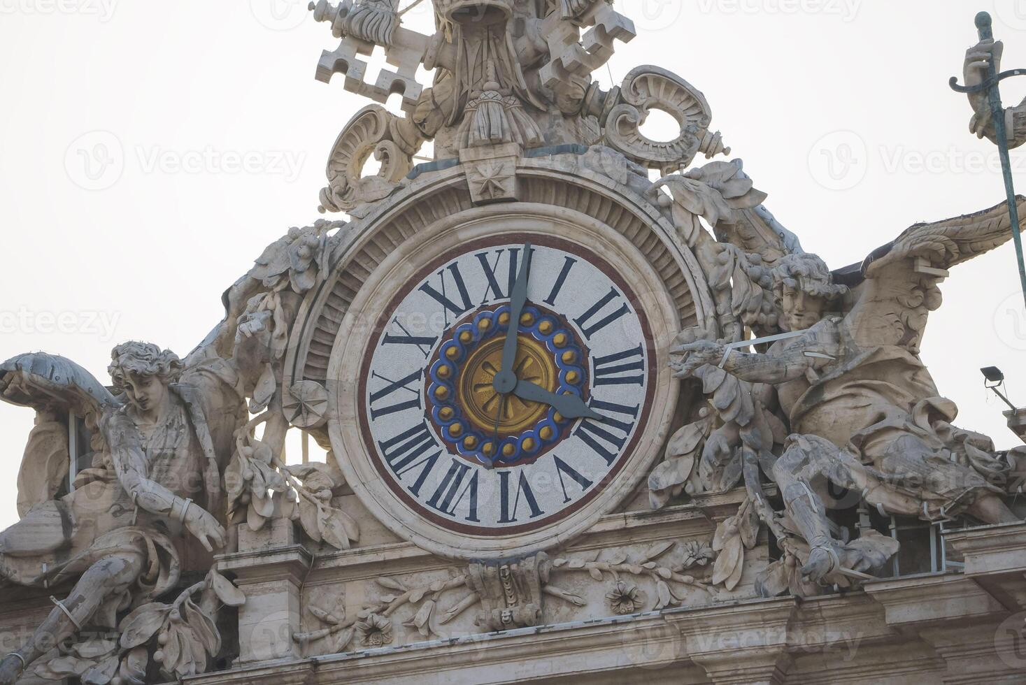 Close up view of the clock on top of the Vatican city. photo
