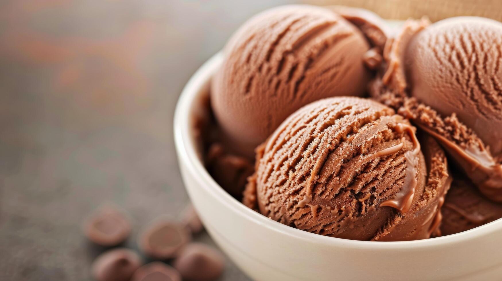 Creamy Chocolate Ice Cream Scoops in a White Bowl on a Rustic Surface photo