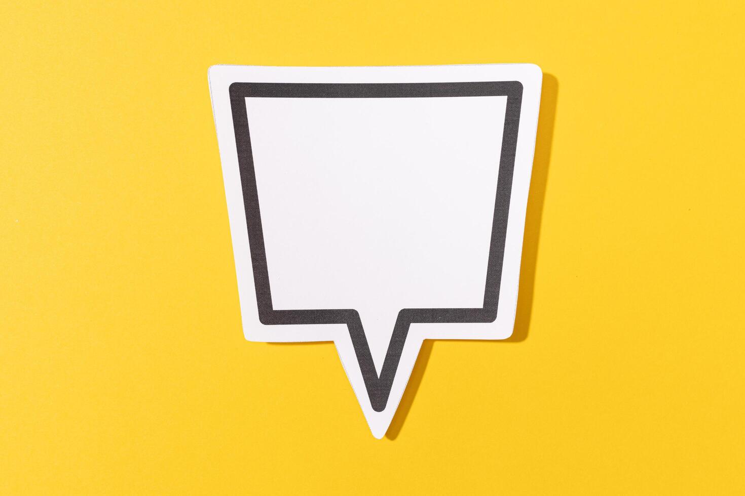 Blank Speech Bubble isolated on yellow background. Mock up template photo