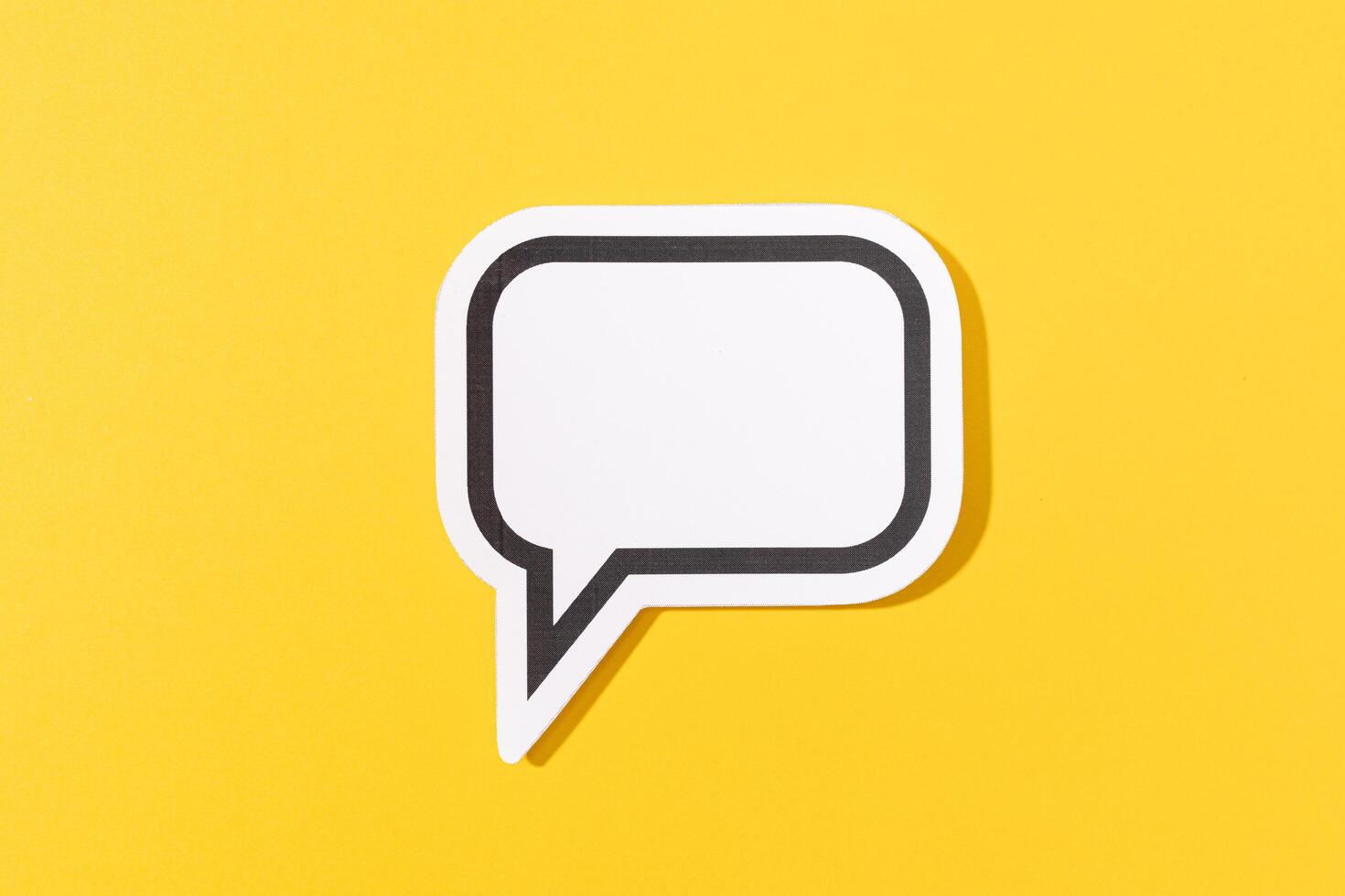 Blank Speech Bubble isolated on yellow background. Mock up template photo