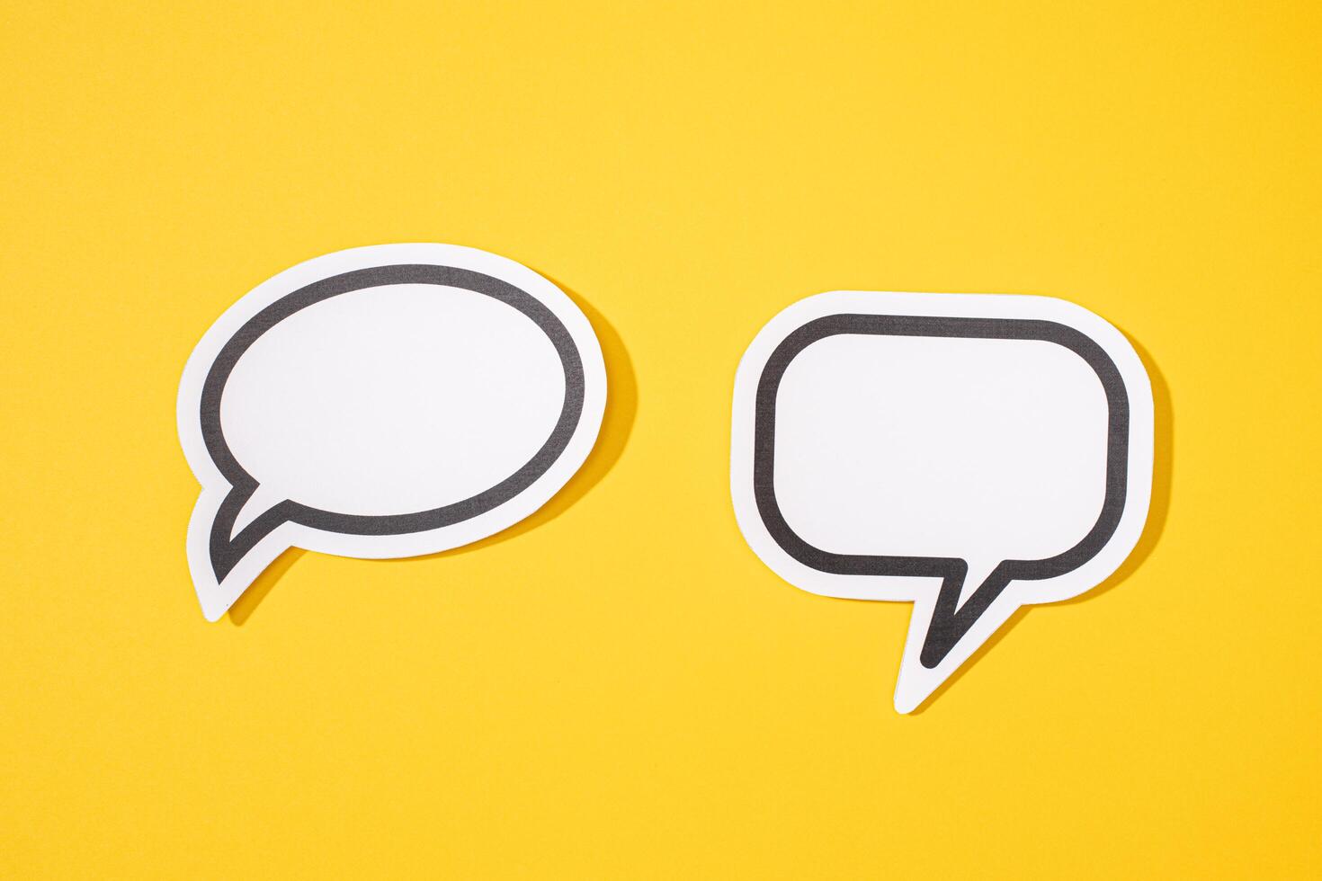 Two Blank Speech Bubble isolated on yellow background. Mock up template photo