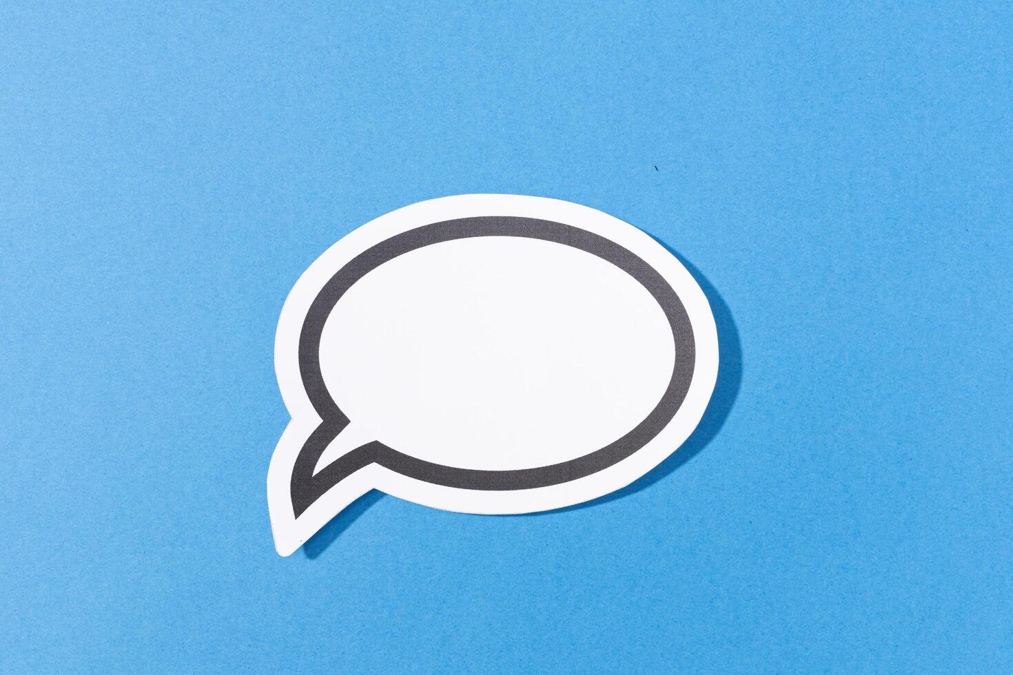 Blank Speech Bubble isolated on blue background. Mock up template photo