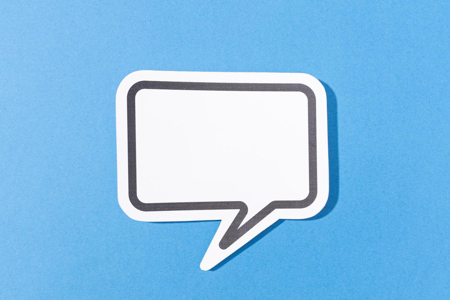 Blank Speech Bubble isolated on blue background. Mock up templateblue background photo