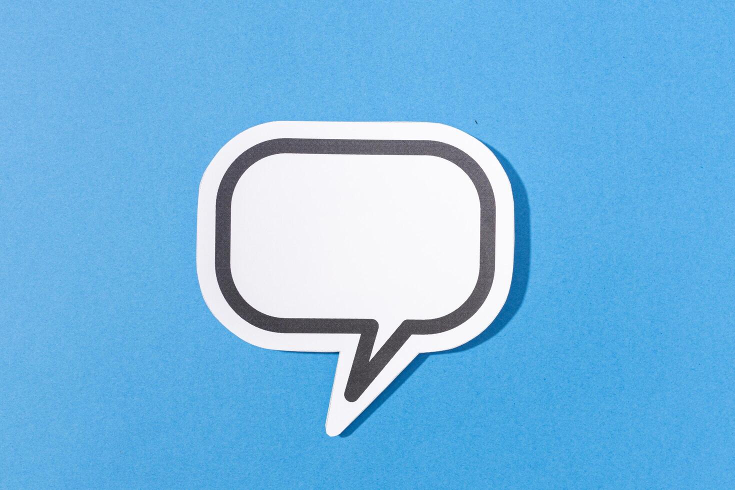 Blank Speech Bubble isolated on blue background. Mock up template photo