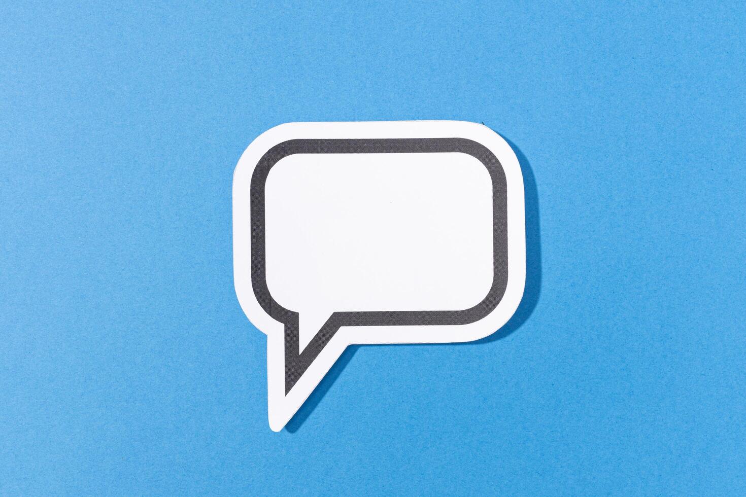 Blank Speech Bubble isolated on blue background. Mock up template photo
