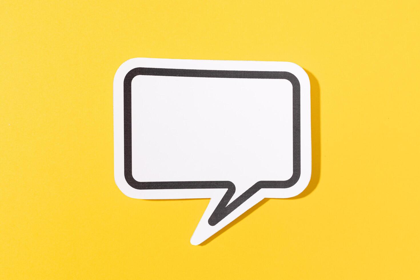 Blank Speech Bubble isolated on yellow background. Mock up template photo