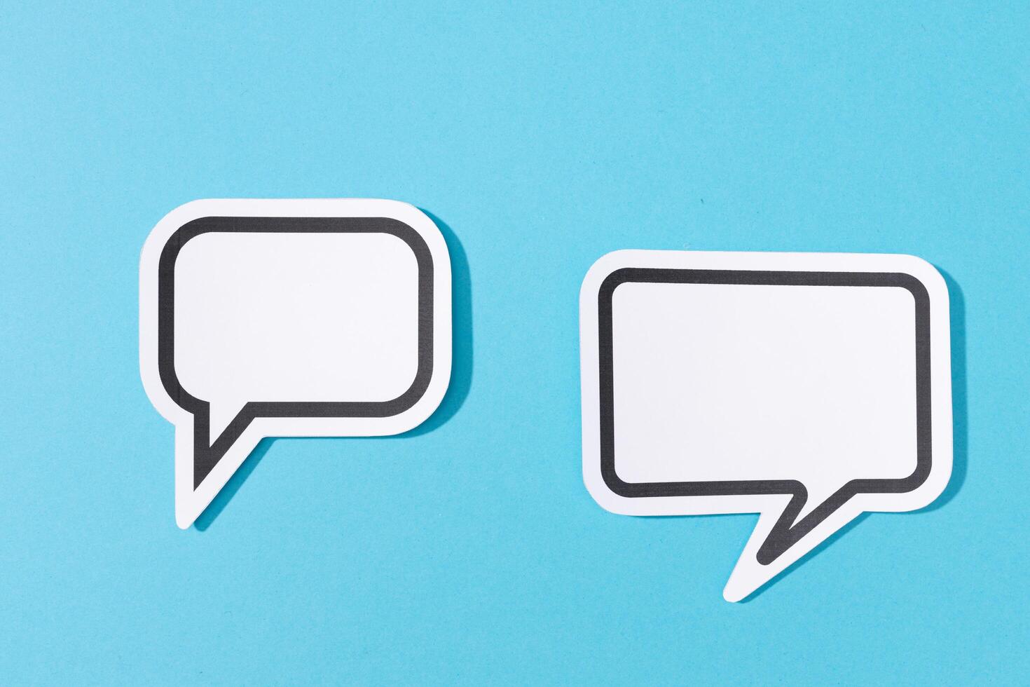 Two Blank Speech Bubble isolated on blue background. Mock up template photo