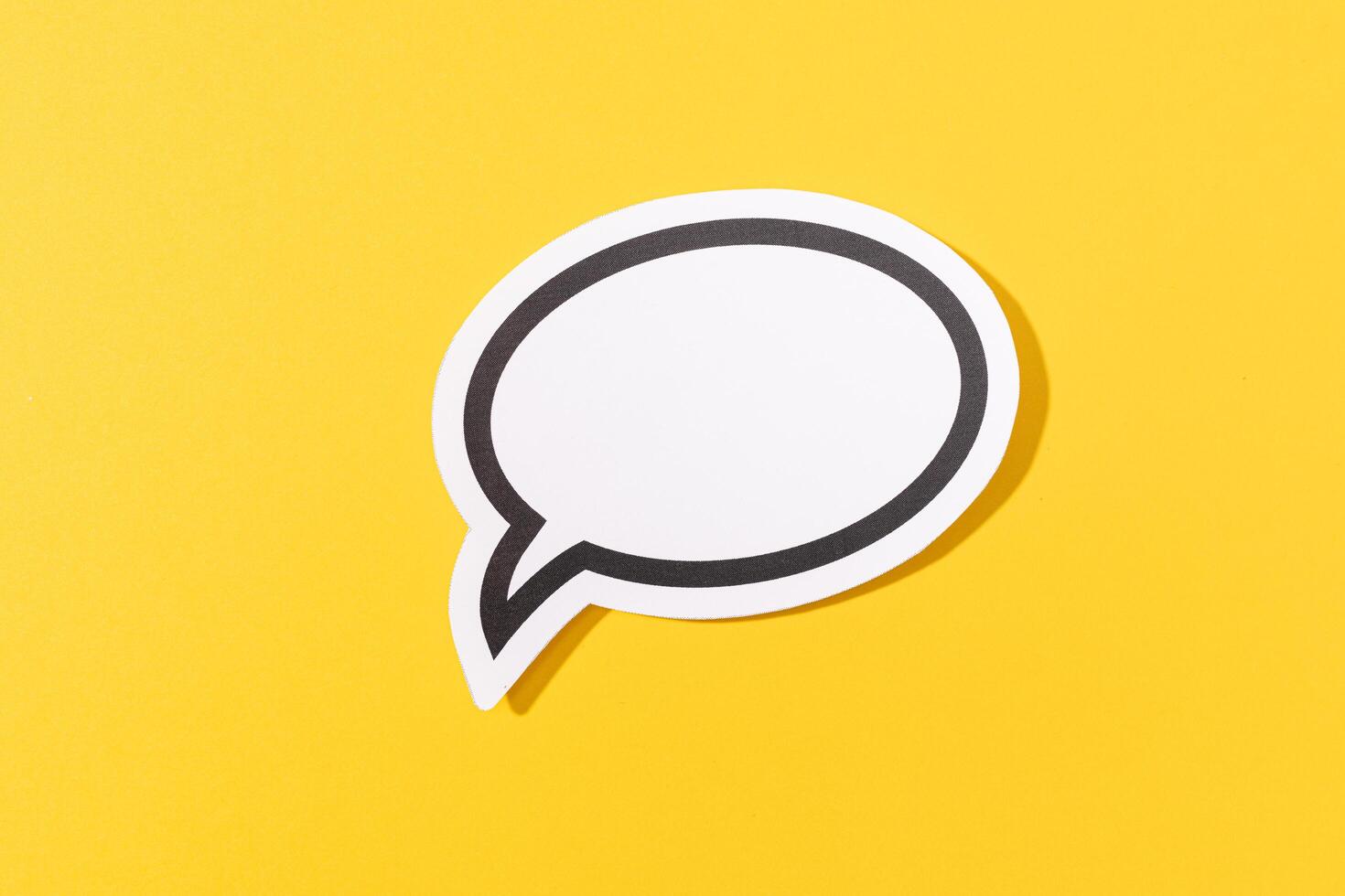 Blank Speech Bubble isolated on yellow background. Mock up template photo