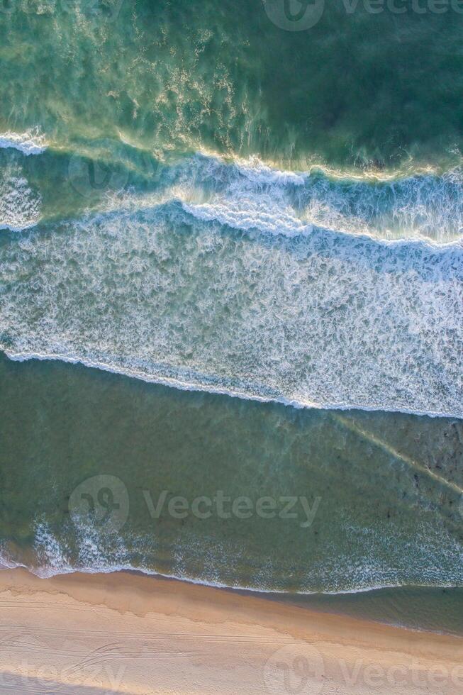 waves on the shore of a deserted beach, aerial view from a drone. Aerial top view from UAV drone photo