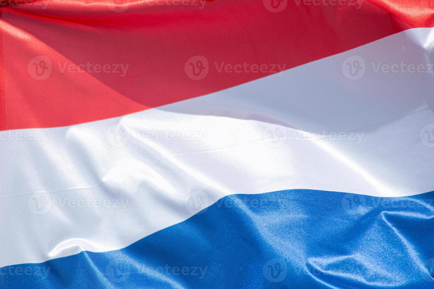 close up view waving dutch flag on a windy day photo