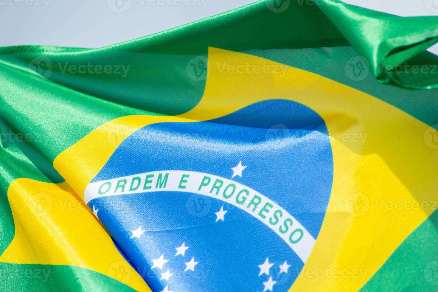 the brazilian flag fluttering against the sky, close up view photo