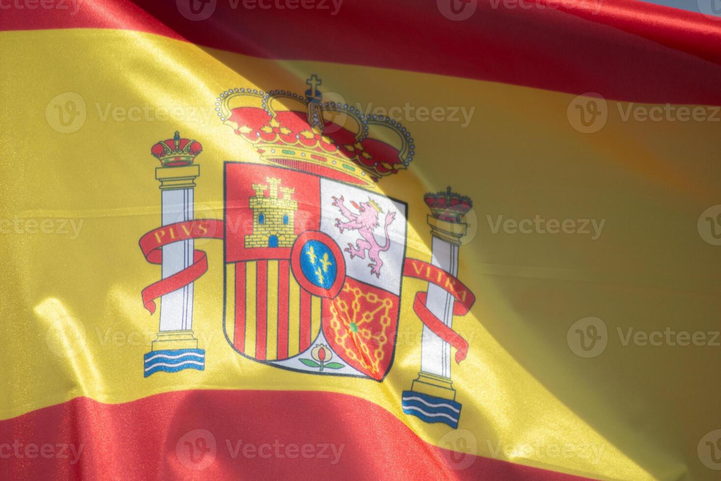 detail of a Spanish flag fluttering in the wind photo