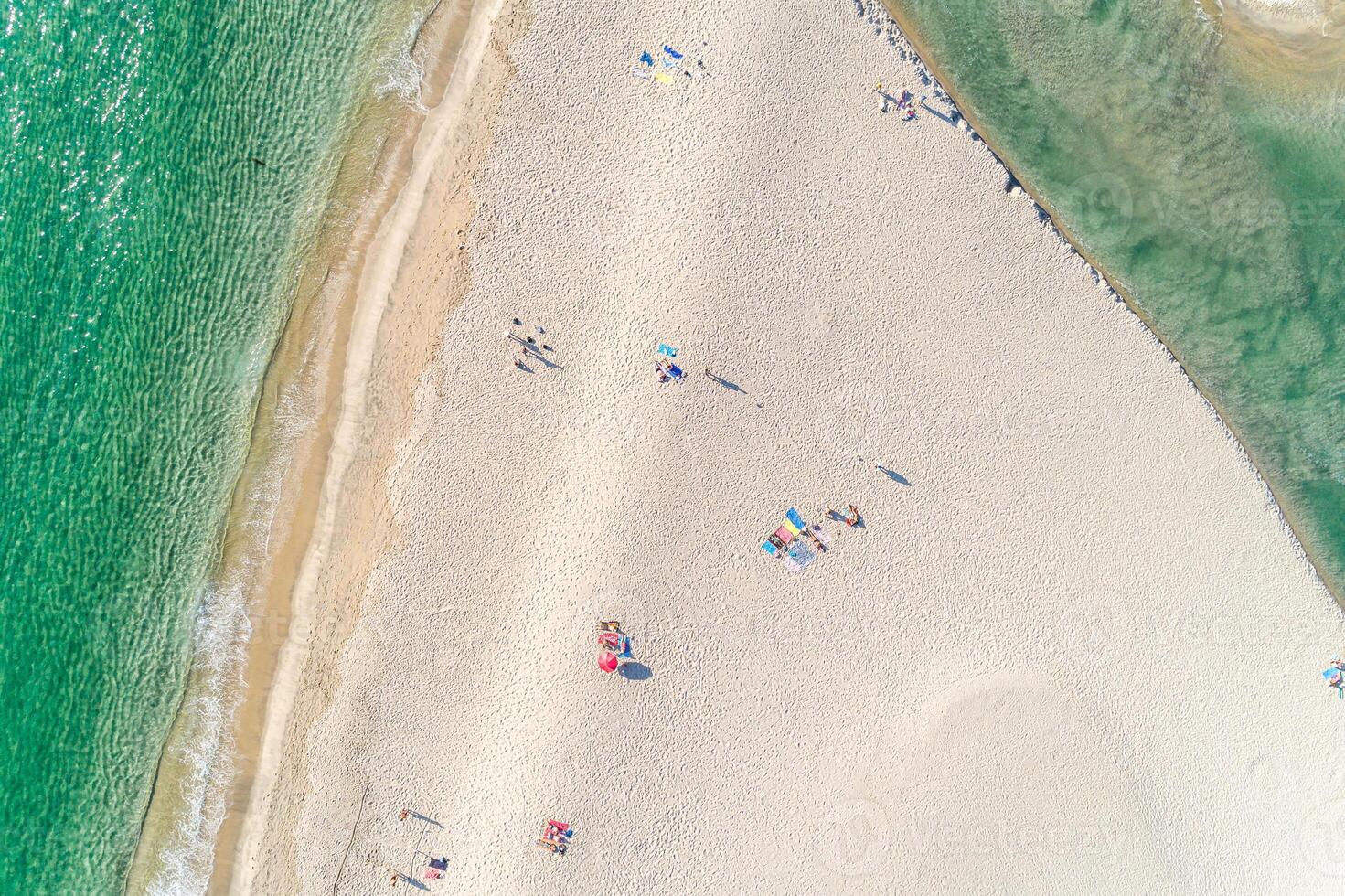 people enjoying the beach in summer, aerial top view with a drone. photo