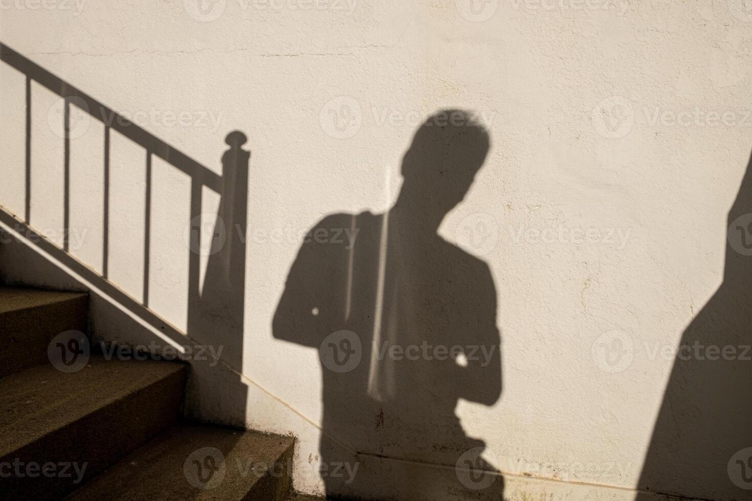 shadow of an adult man on a wall photo