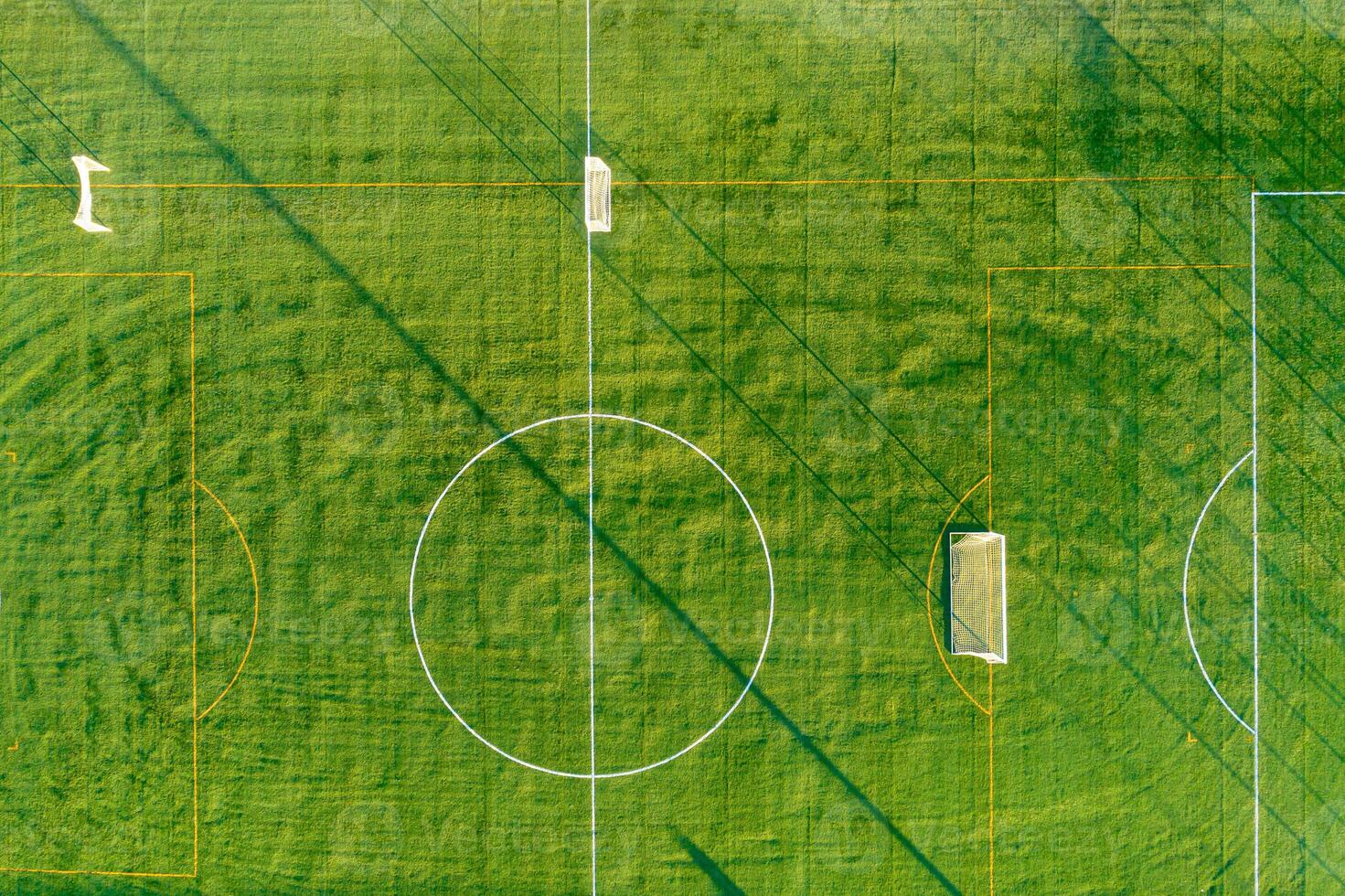 empty soccer field with the goals set up for training, aerial overhead view from a drone. photo