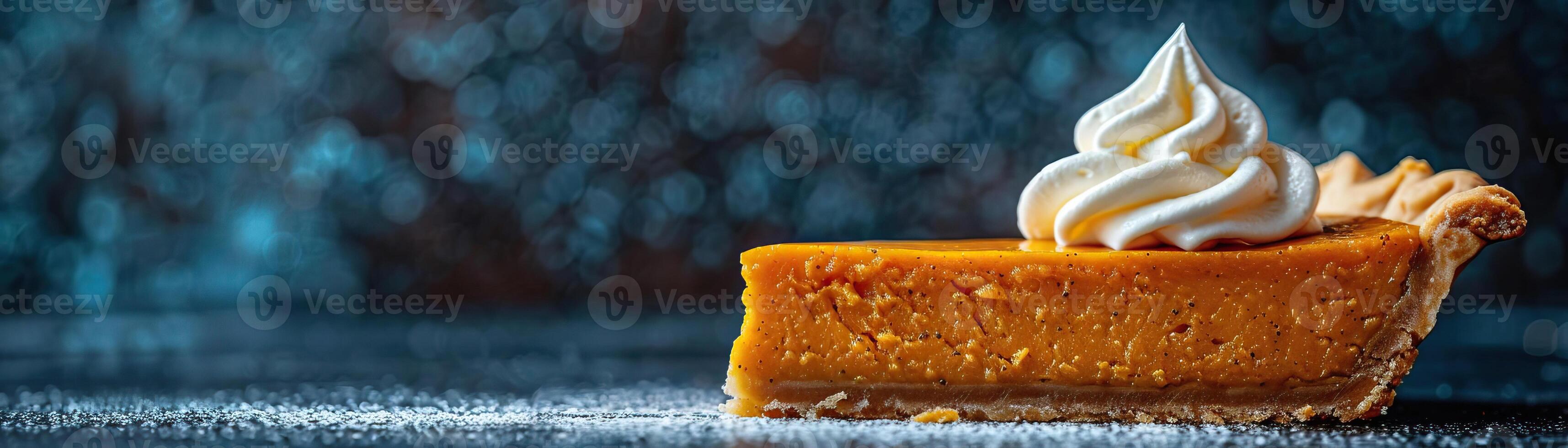 A minimalist composition featuring a piece of pumpkin pie with a perfect peak of whipped cream, set against a dark, textured backdrop, panoramic space above for copy. photo