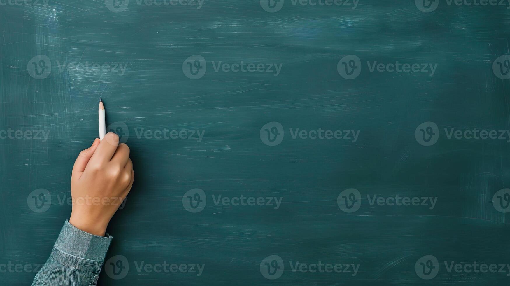 Engaged student taking notes in front of a chalkboard, learning and curriculum, education concept, editorial shot, empty space for text on side photo