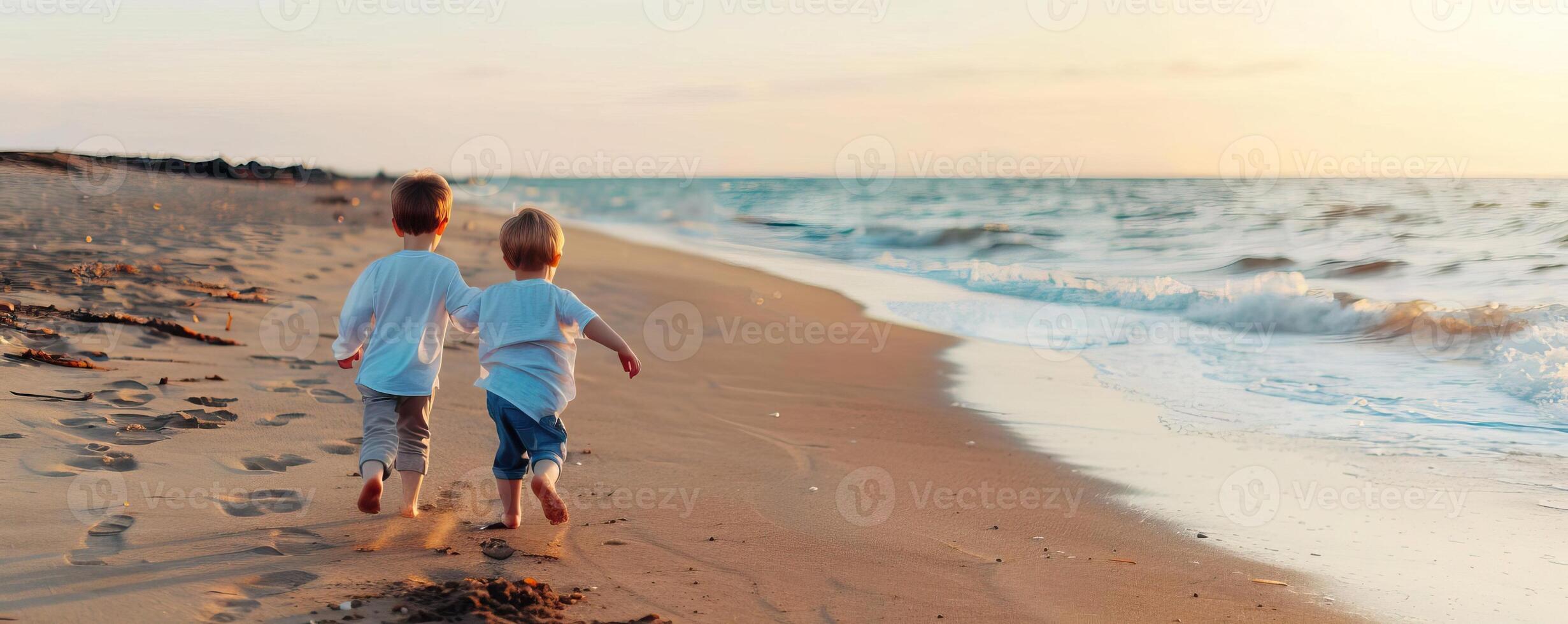 Happy siblings running along the shoreline, carefree and fun, beach break, editorial photography, empty space for text on left photo