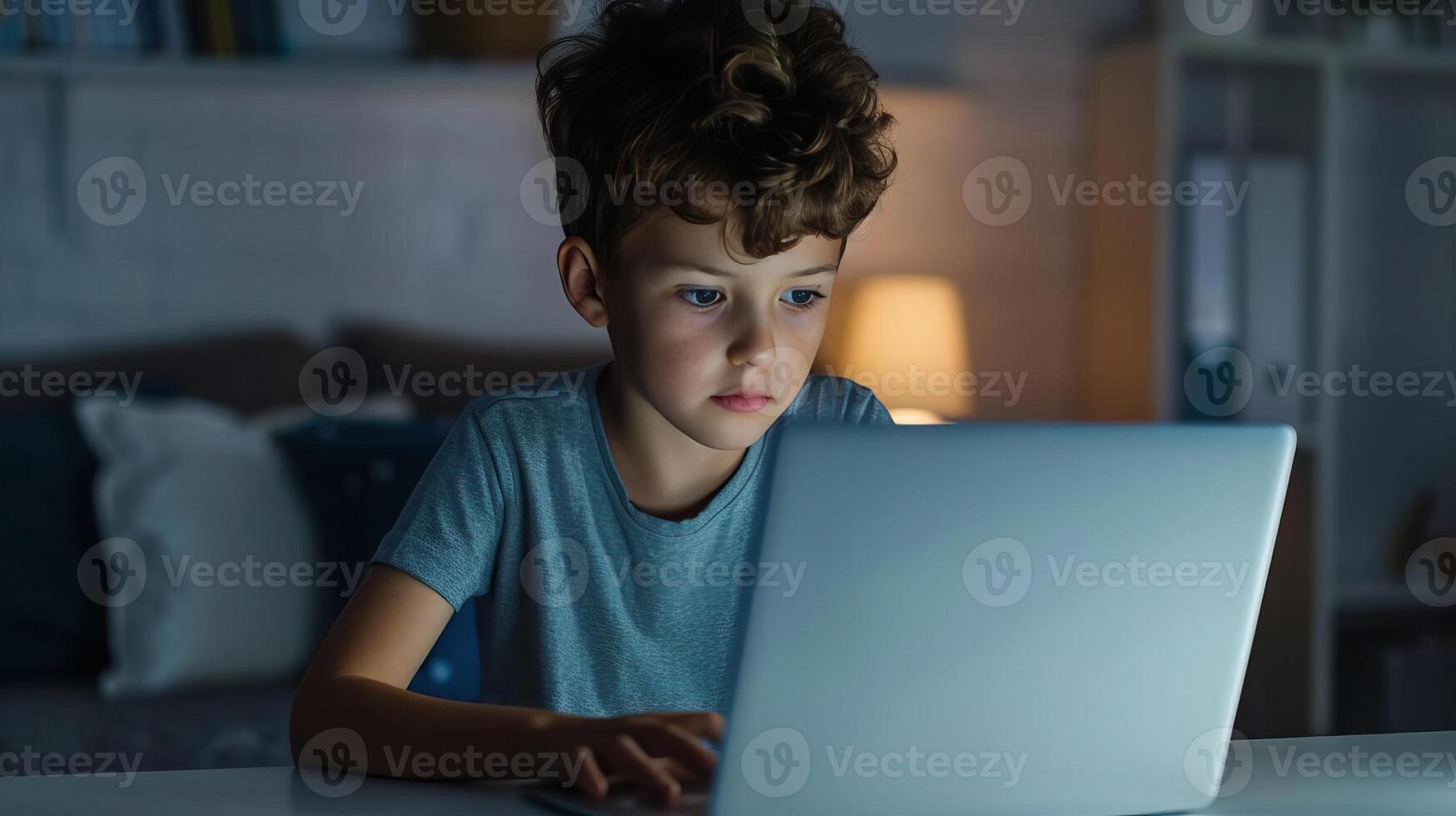 Kid using a laptop for study at a desk, modern education concept, editorial photography, empty copy space for text photo