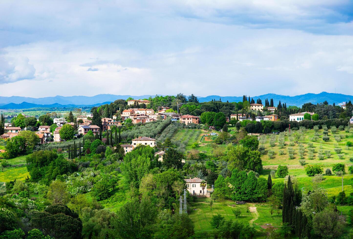 Tuscany, Italy-April 21, 2024 Charming Tuscan Village Amidst Olive Groves photo