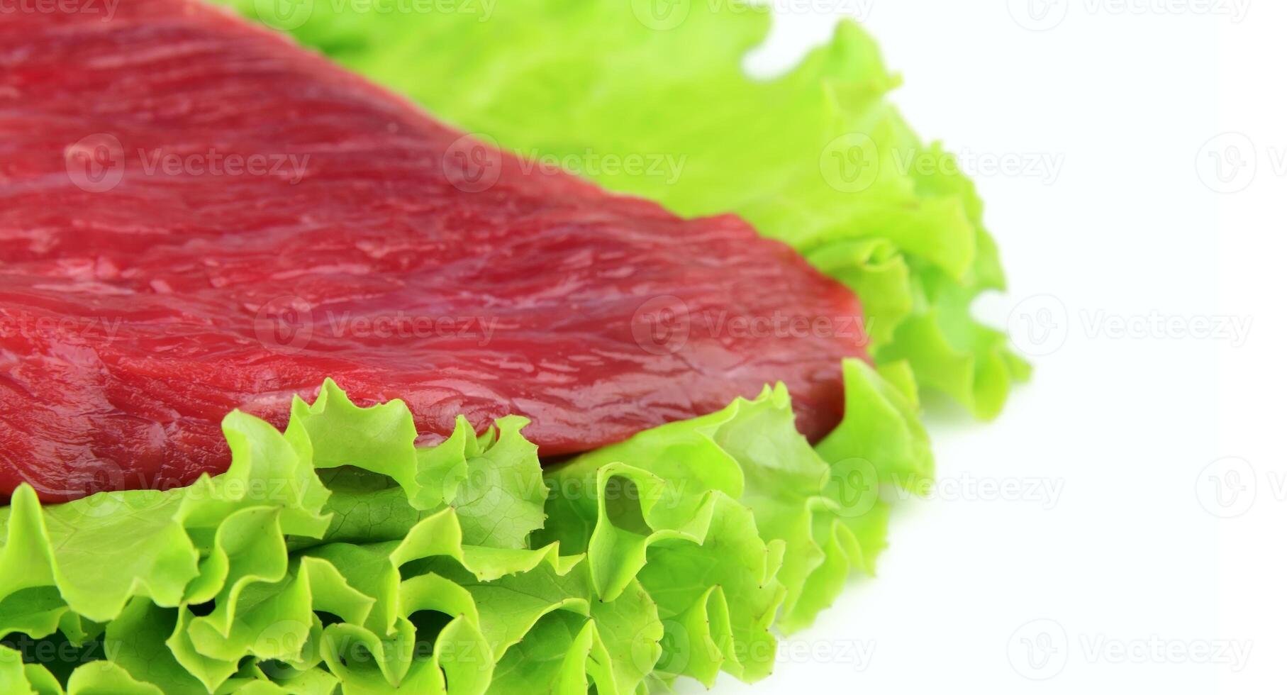 Crude meat with lettuce close up photo