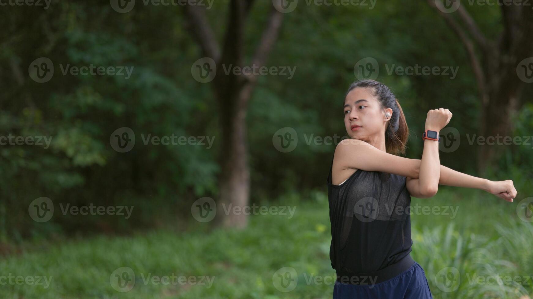 A woman is stretching in a park photo