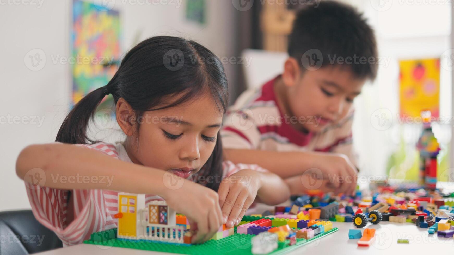 A boy is holding a toy with a number of faces on it photo