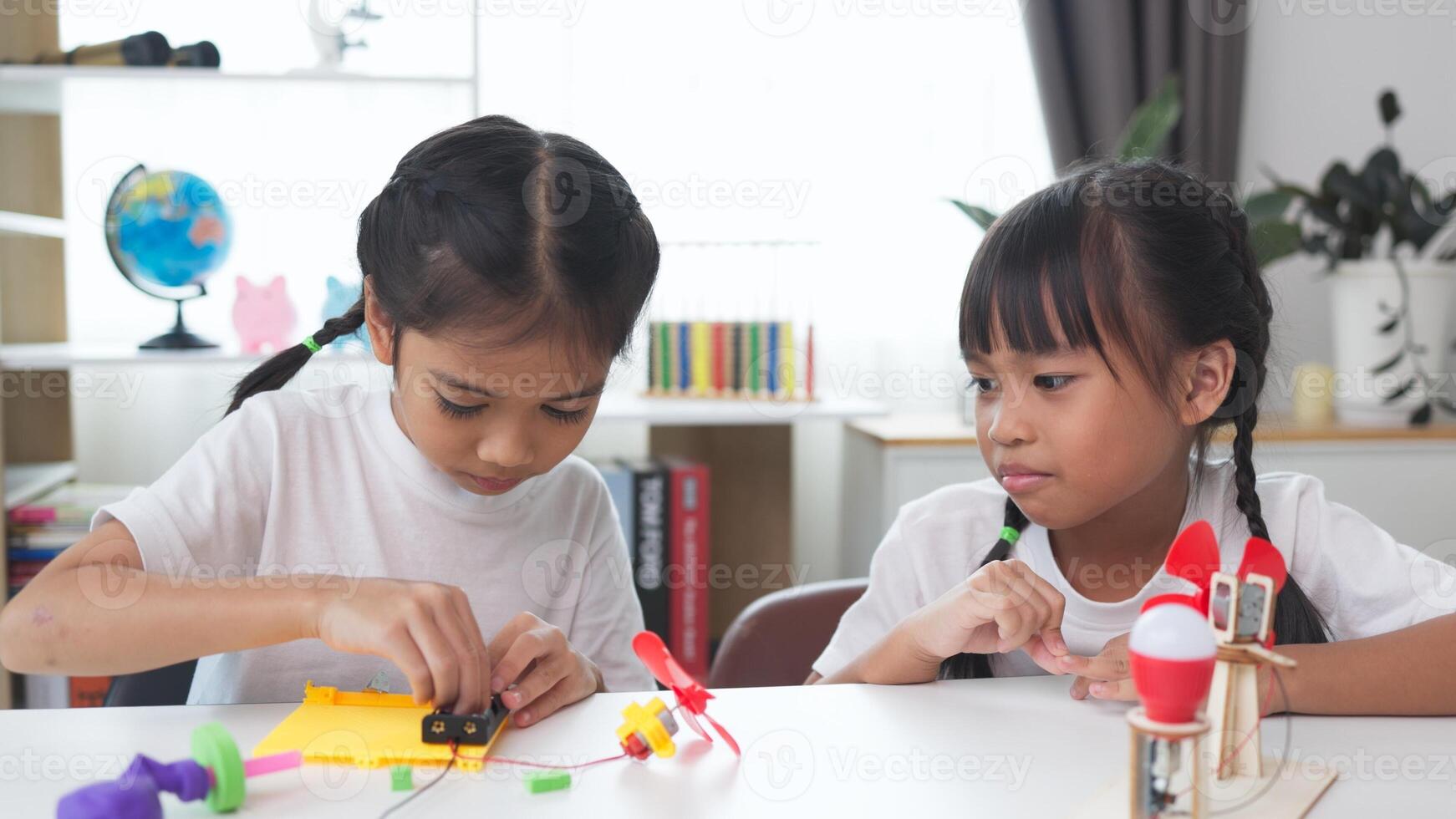 STEM education concept. Asian students learn at home with STEM toys, mathematics engineering science technology computer code in robotics for kids' concepts. photo
