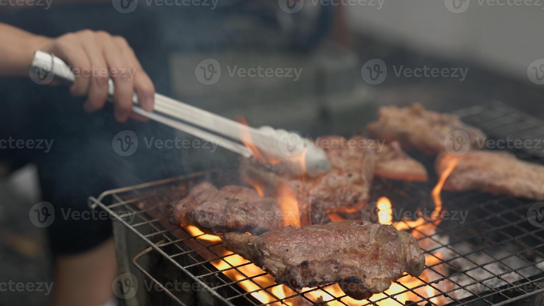 Grilled meat steak Making barbecue at a party camping. Food and cuisine concept. photo