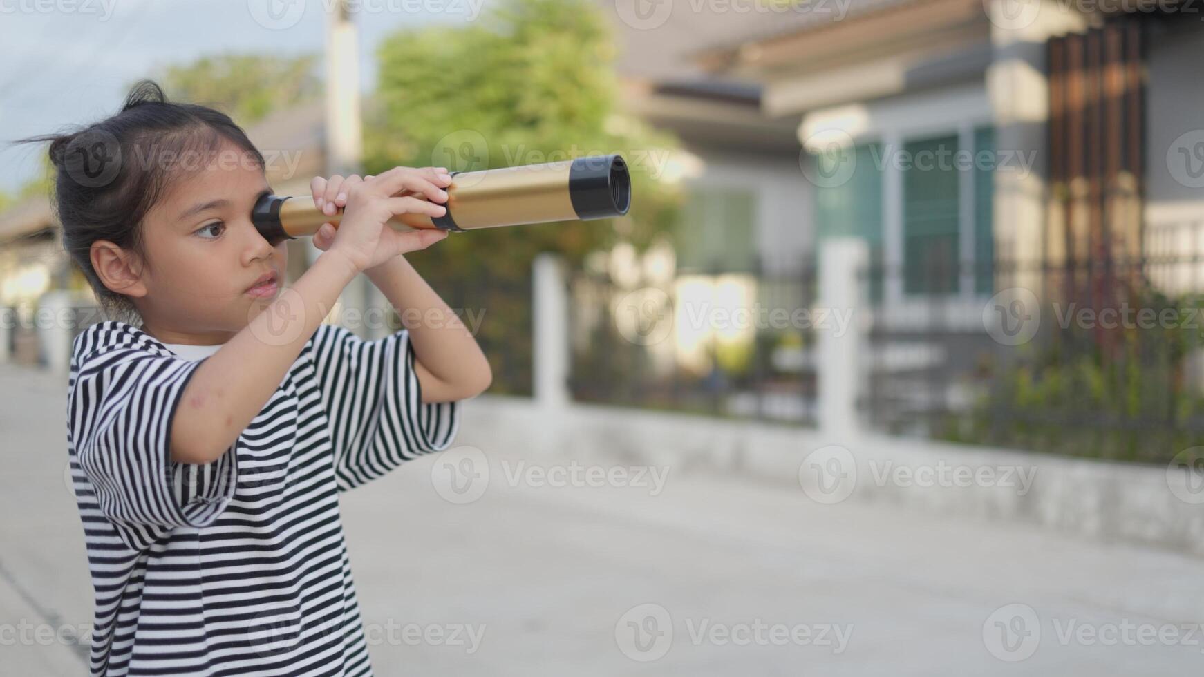 Happy kid looking ahead. Smiling child with the binoculars. Travel and adventure concept. Freedom, vacation photo