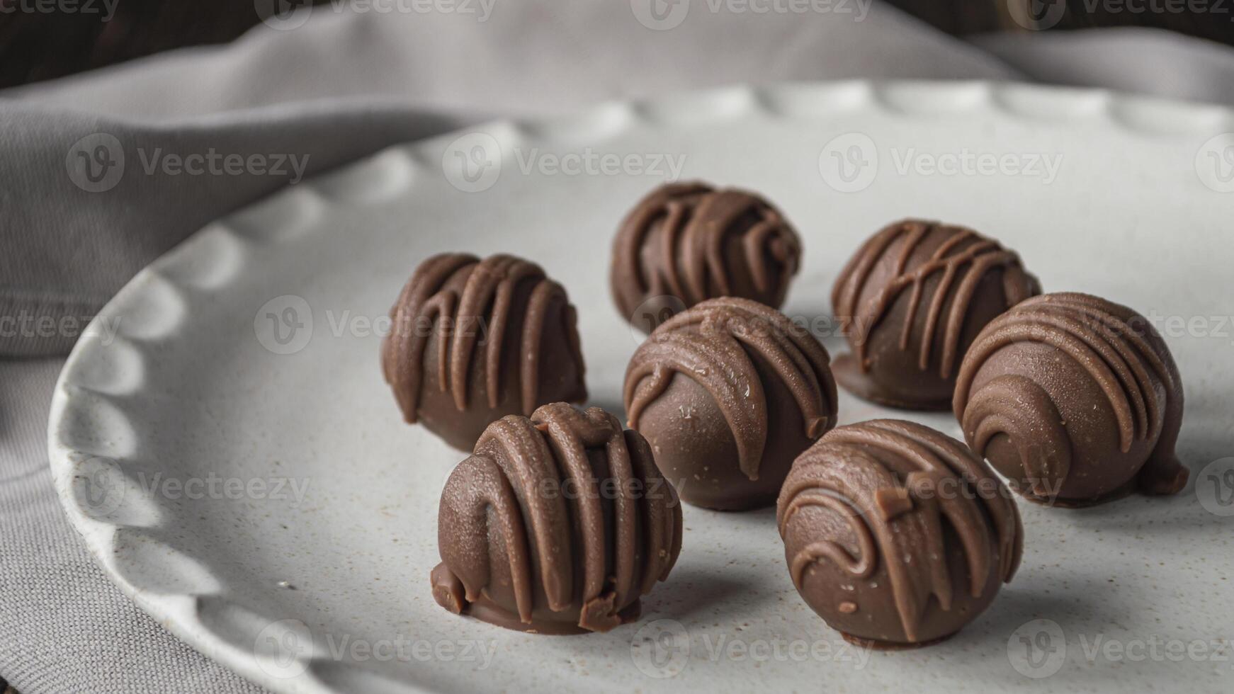 chocolate balls on a white plate photo