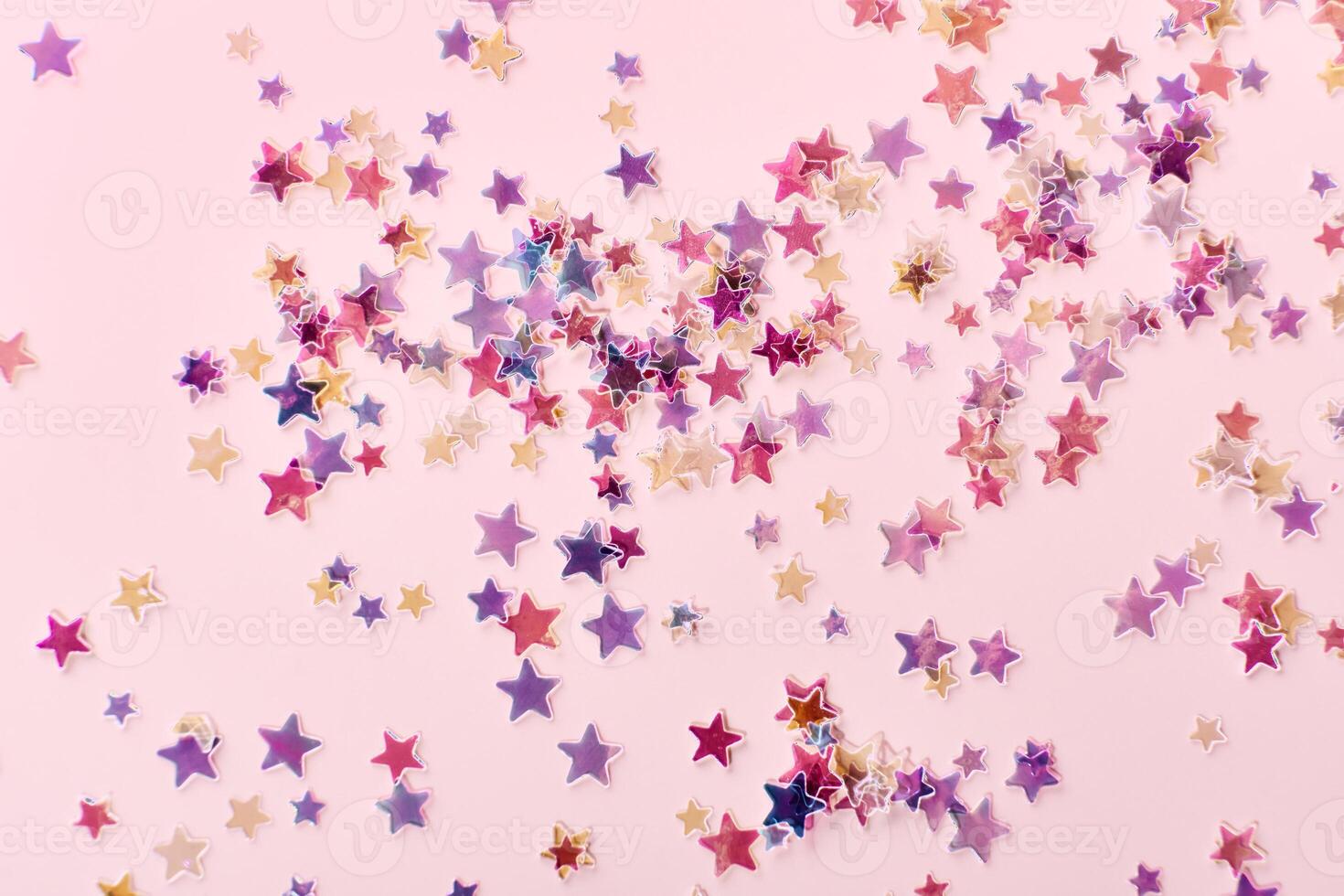 Pink and lilac holographic Stars Glitter Confetti on pink background. Festive backdrop photo