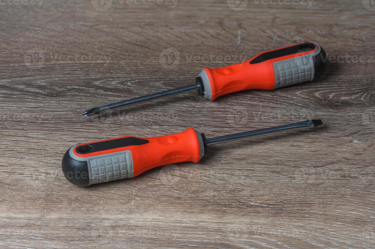 Set of screwdrivers on wooden table, above view photo