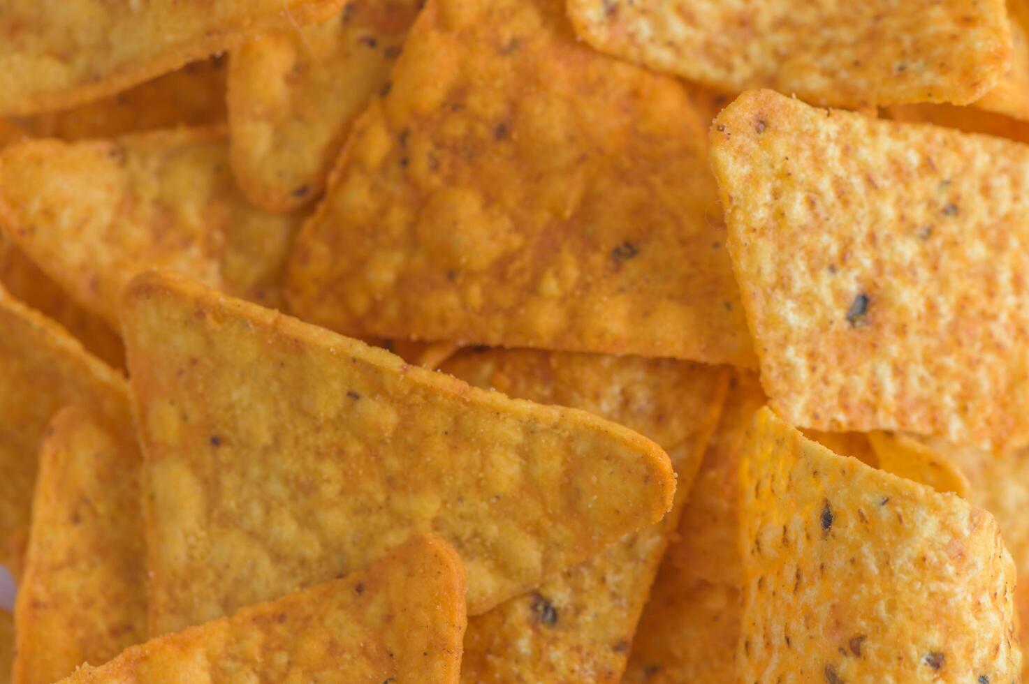 Close-up of a stack of cheese-flavored corn chips photo