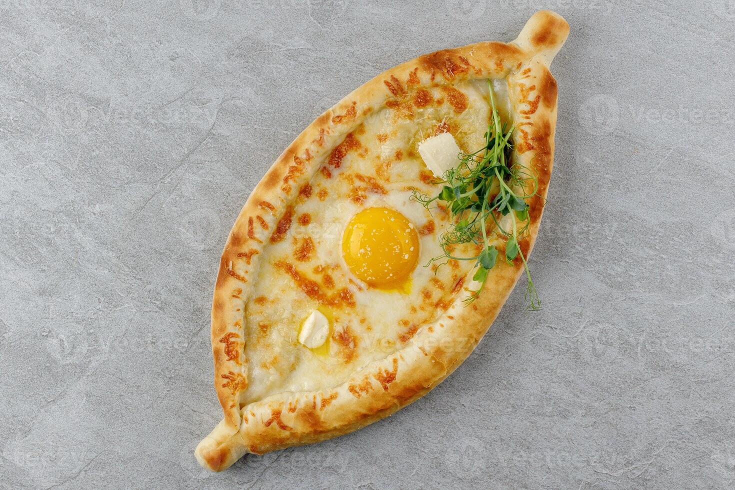 khachapuri in Adjarian style on a stone background studio food photo 3