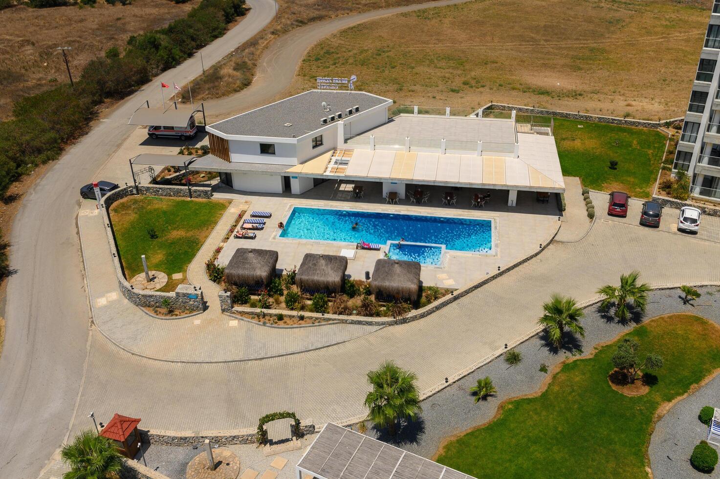 A top down shot directly above an pool, surrounded by green grass and trees photo