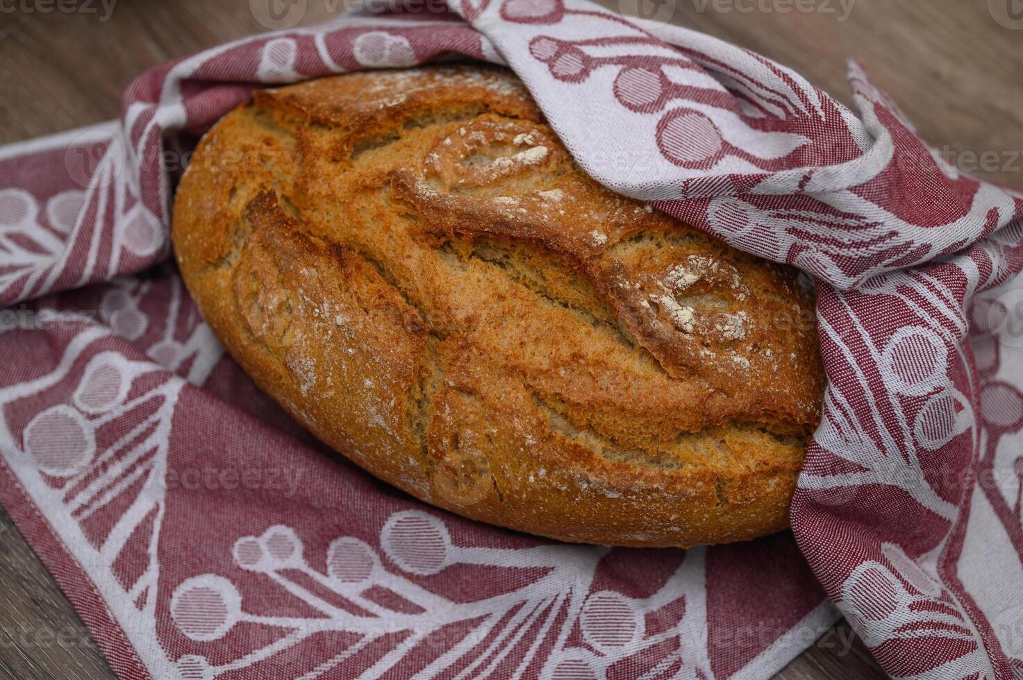 freshly baked homemade bread in a towel in the kitchen 1 photo