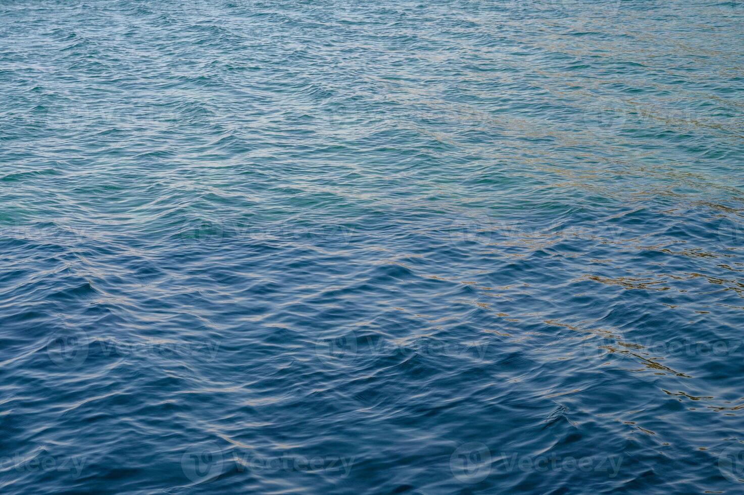 Top view of blue frothy sea surface. Shot in the open sea from above. photo
