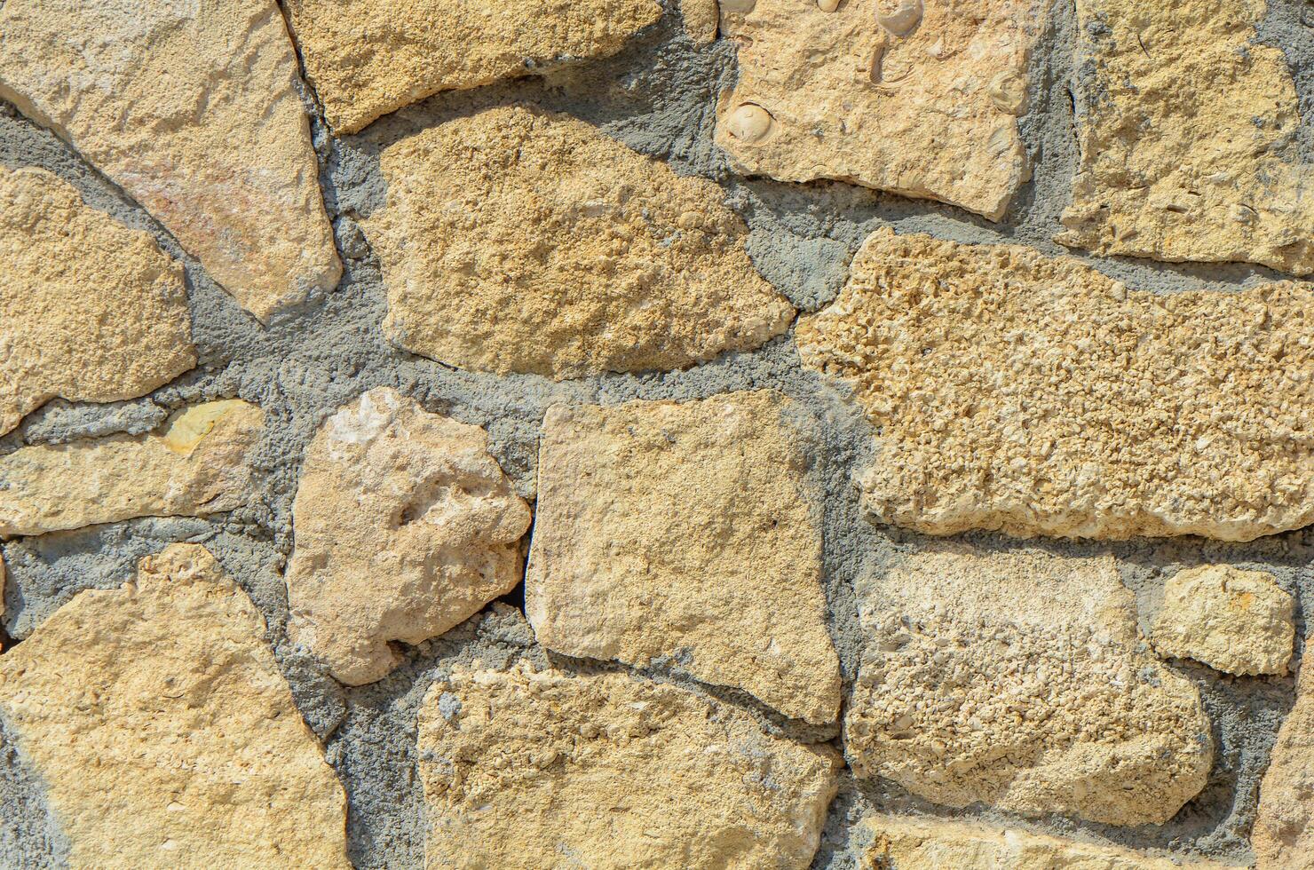 pattern decorative uneven cracked real stone wall surface with cement. with copy space image. Place for adding text or design photo