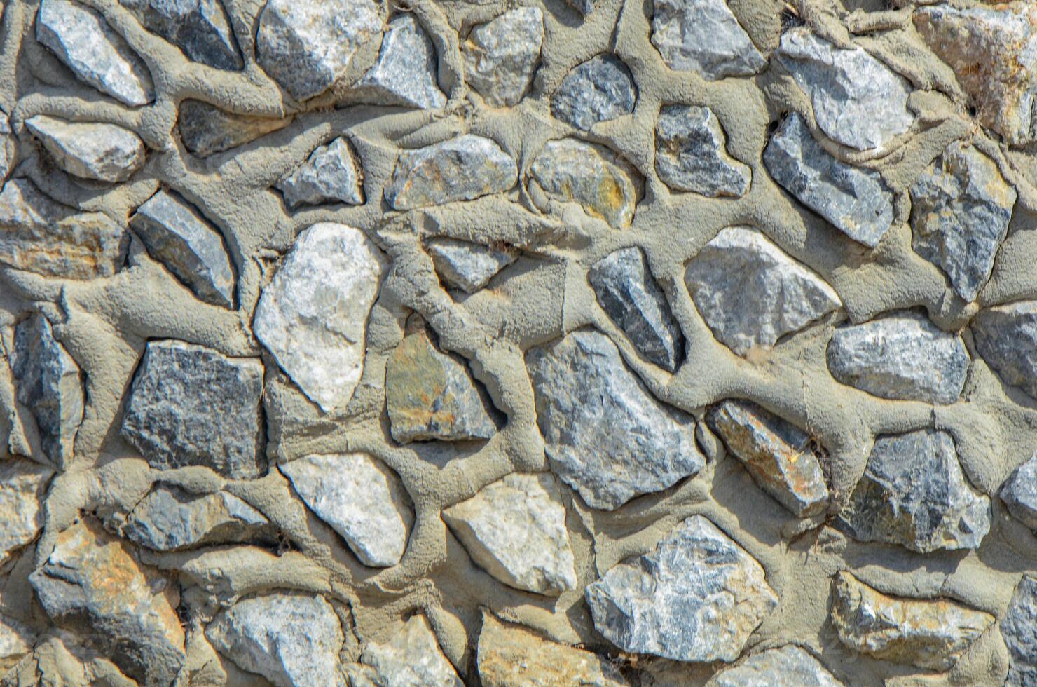 Full frame of a facade of a wall of stone constructed with volcanic rocks of origin photo