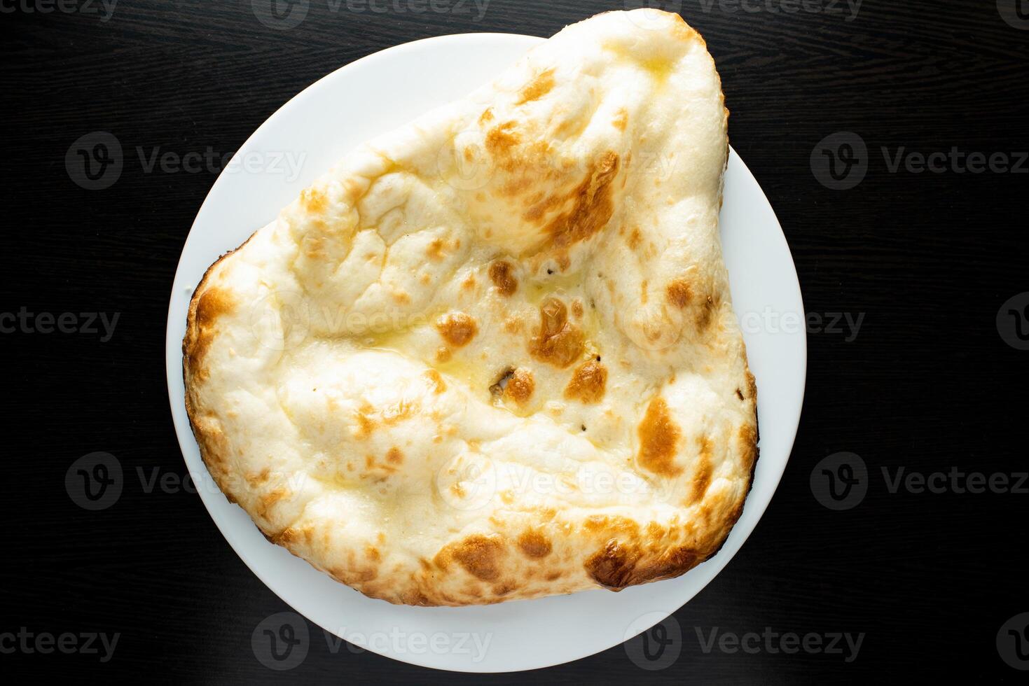 Tandoori Butter Naan, nan, nun, bread or roti served in dish isolated dark background top view of indian spices, bangladeshi and pakistani food photo