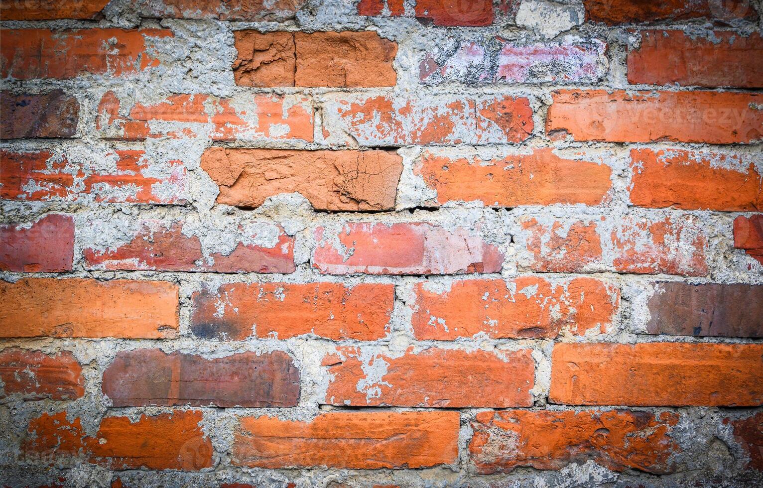 Old and aged red brick wall texture background with vignetting photo