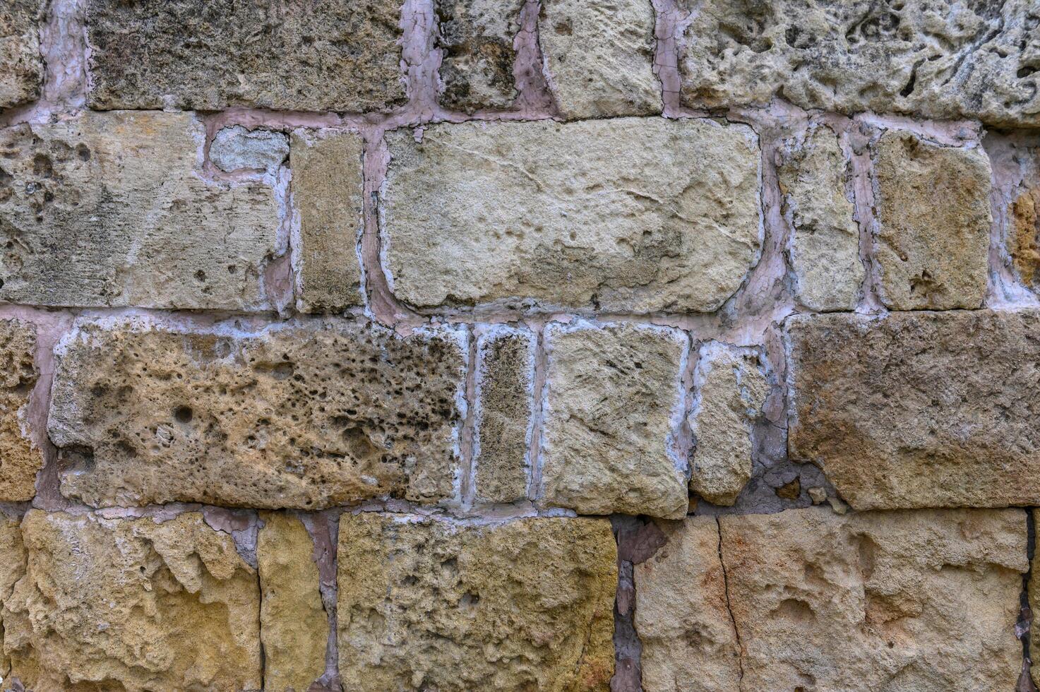 Stone wall, background. Light and shadow. Ancient town . Archaelogical site photo