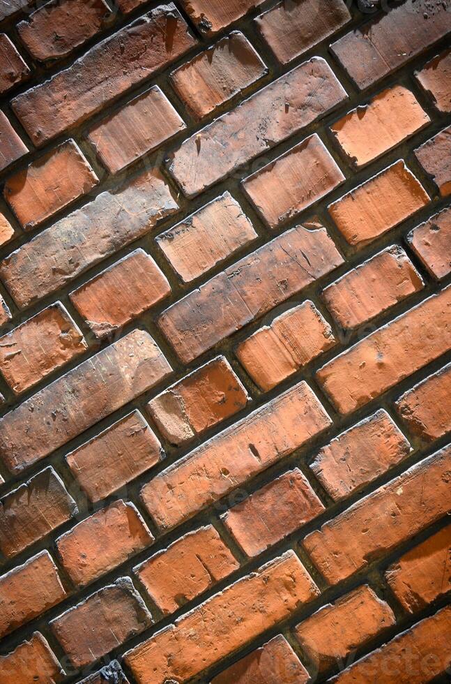 Old and aged red brick wall texture background with vignetting.2 photo