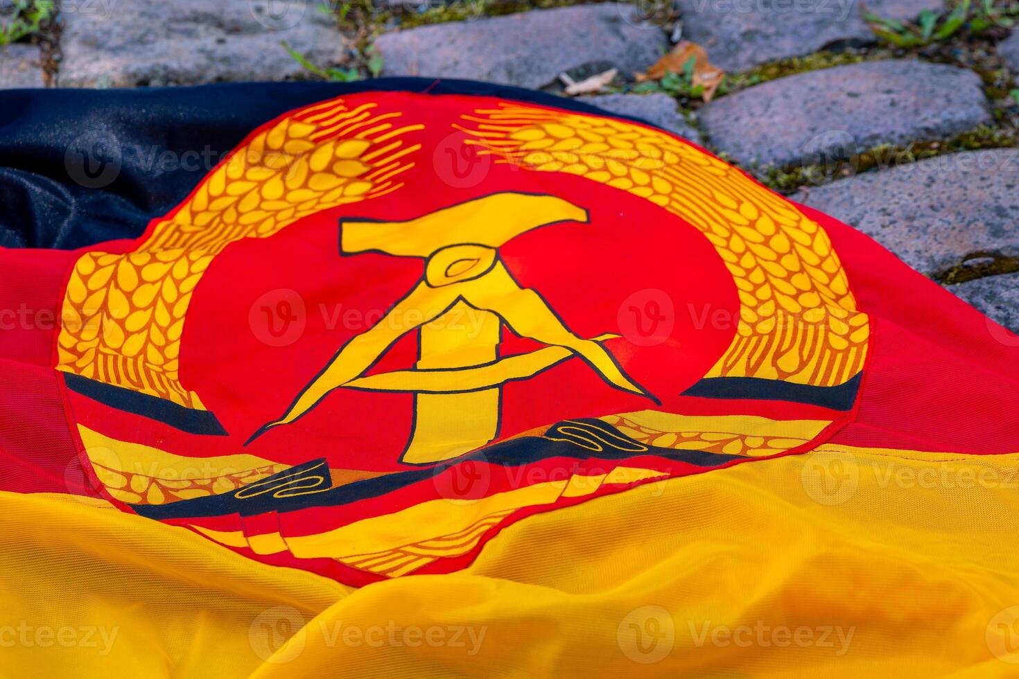an old gdr flag with hammer and compass photo